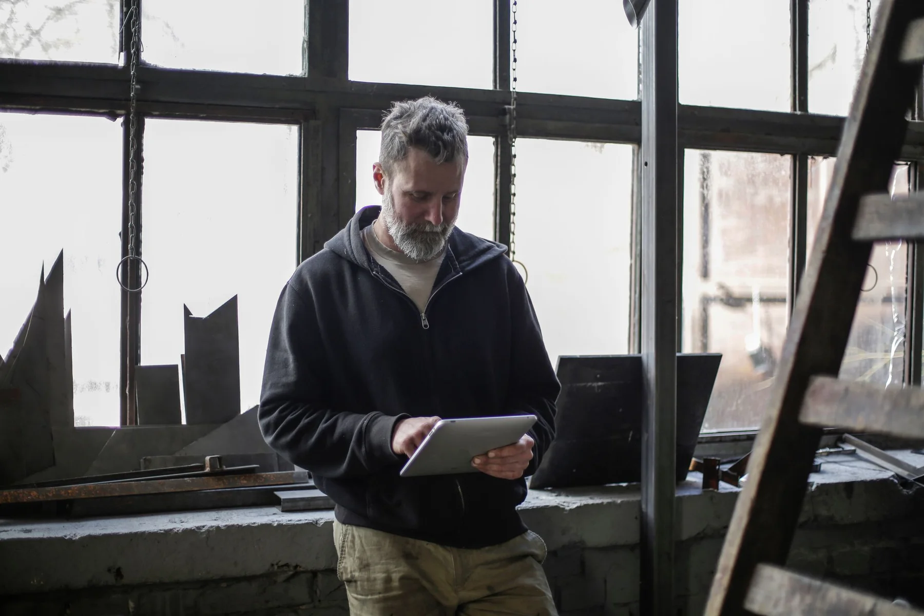 A technician reviewing information on a tablet in a workshop